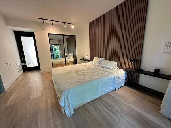 a bedroom with a bed and a mirror