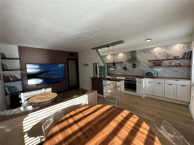 a kitchen with stainless steel appliances kitchen island granite countertop a sink and cabinets