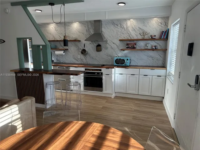 a kitchen with stainless steel appliances granite countertop a stove and a refrigerator