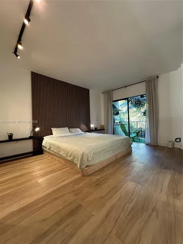 a bedroom with a large bed and a large window