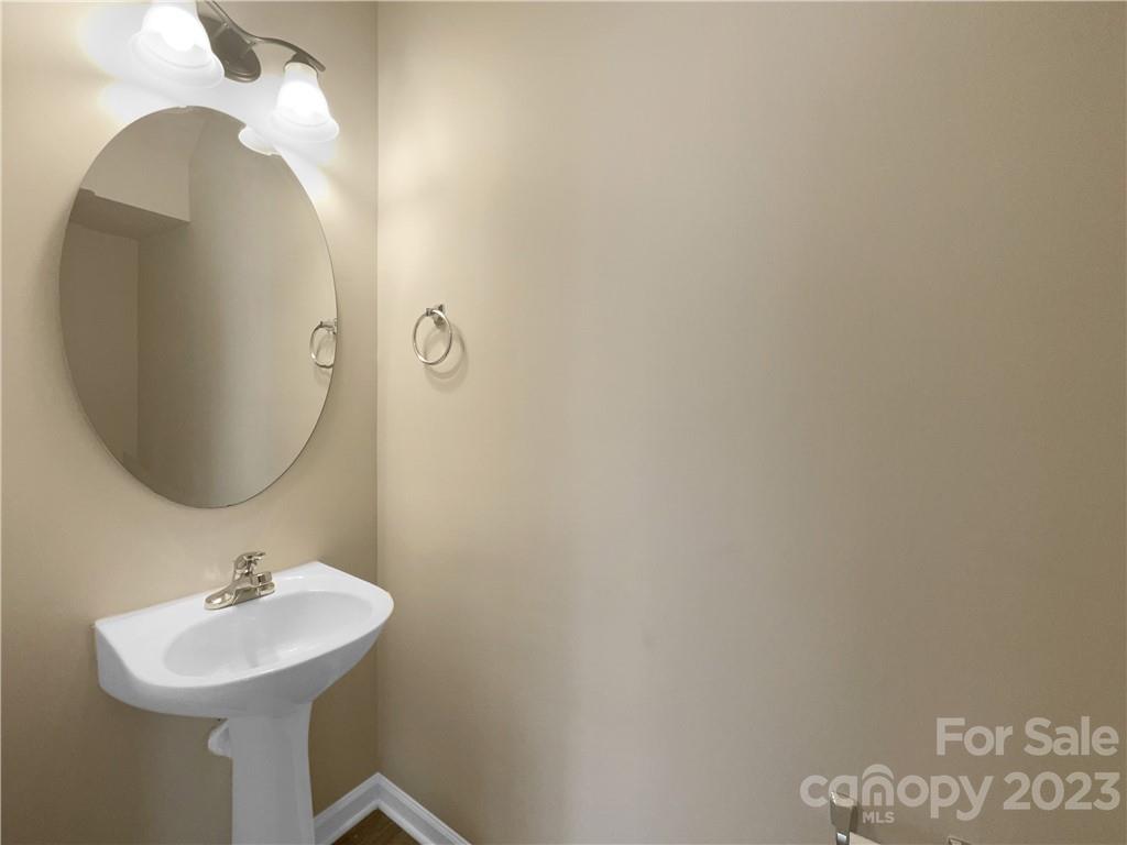 10775 Traders Court Davidson, NC 28036 - Photo 14 of 28 a bathroom with a sink mirror and vanity