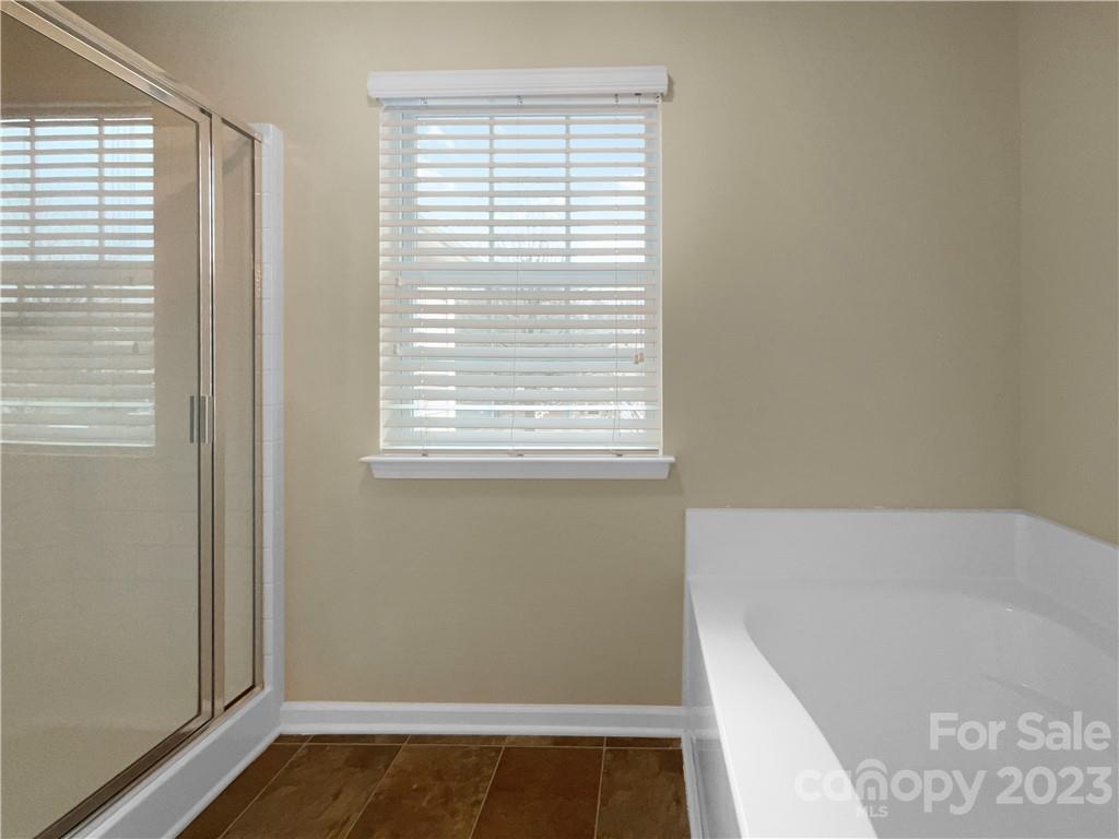 10775 Traders Court Davidson, NC 28036 - Photo 26 of 28 a bathroom with a bathtub and a window