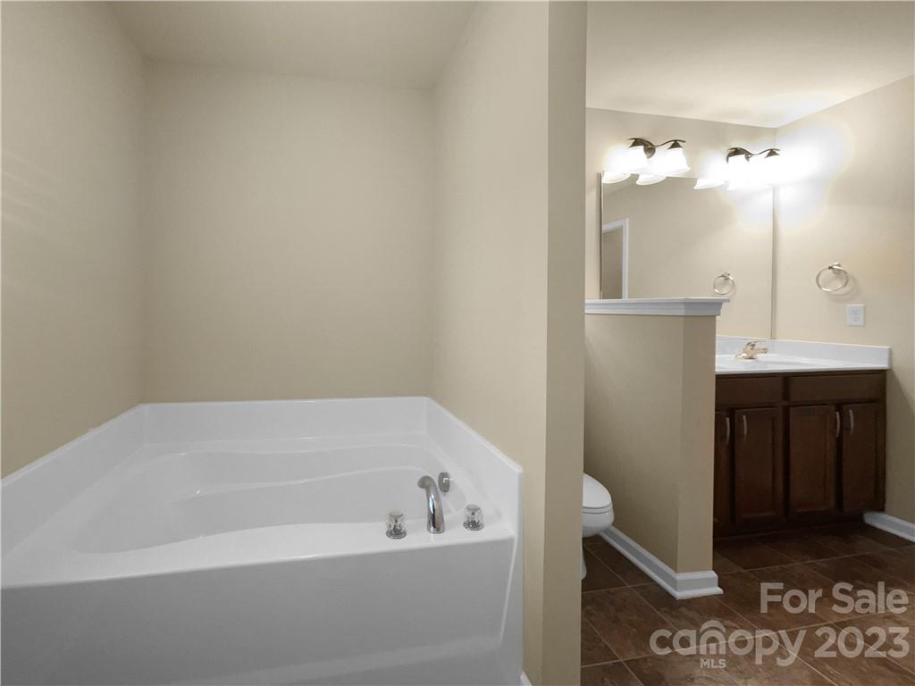 10775 Traders Court Davidson, NC 28036 - Photo 27 of 28 a bathroom with a bathtub and a sink