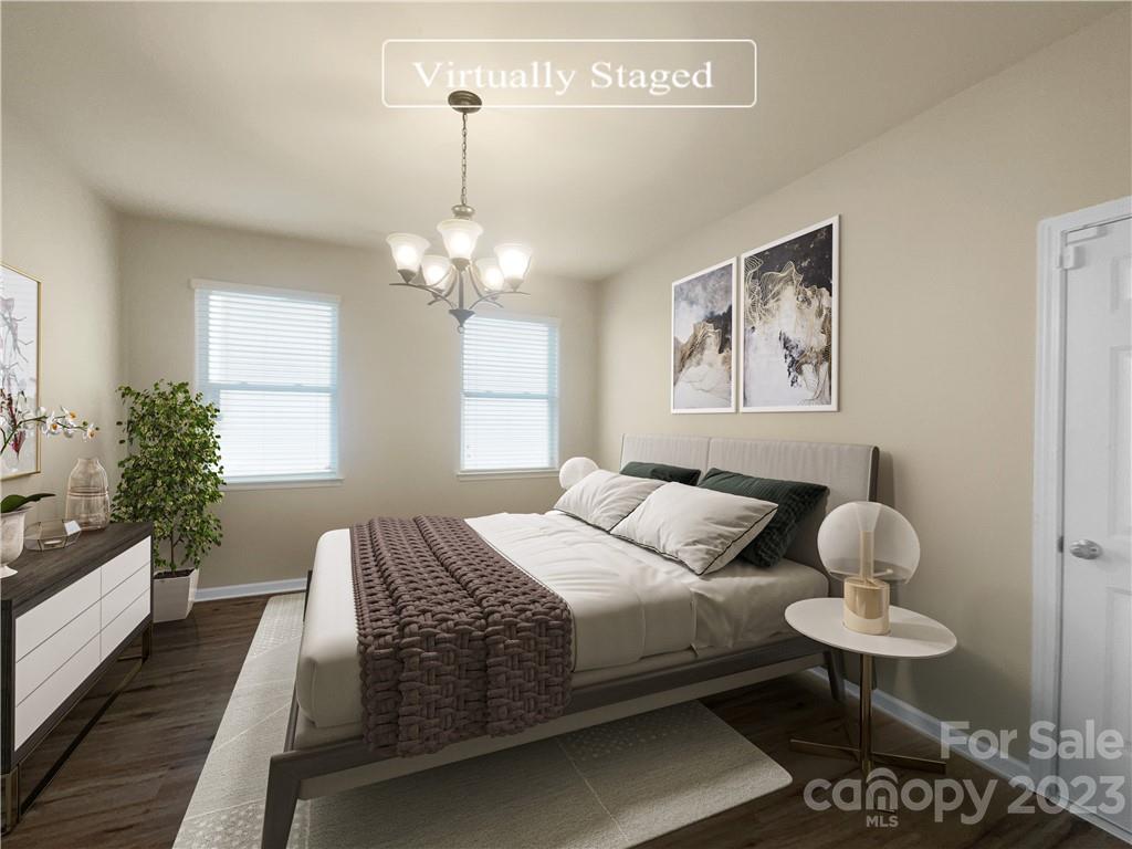 10775 Traders Court Davidson, NC 28036 - Photo 4 of 28 a bedroom with a bed and a chandelier