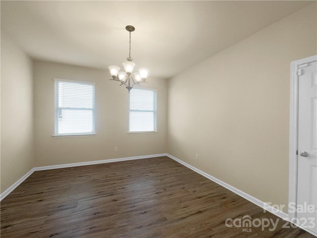 10775 Traders Court Davidson, NC 28036 - Photo 5 of 28 wooden floor in an empty room with a window