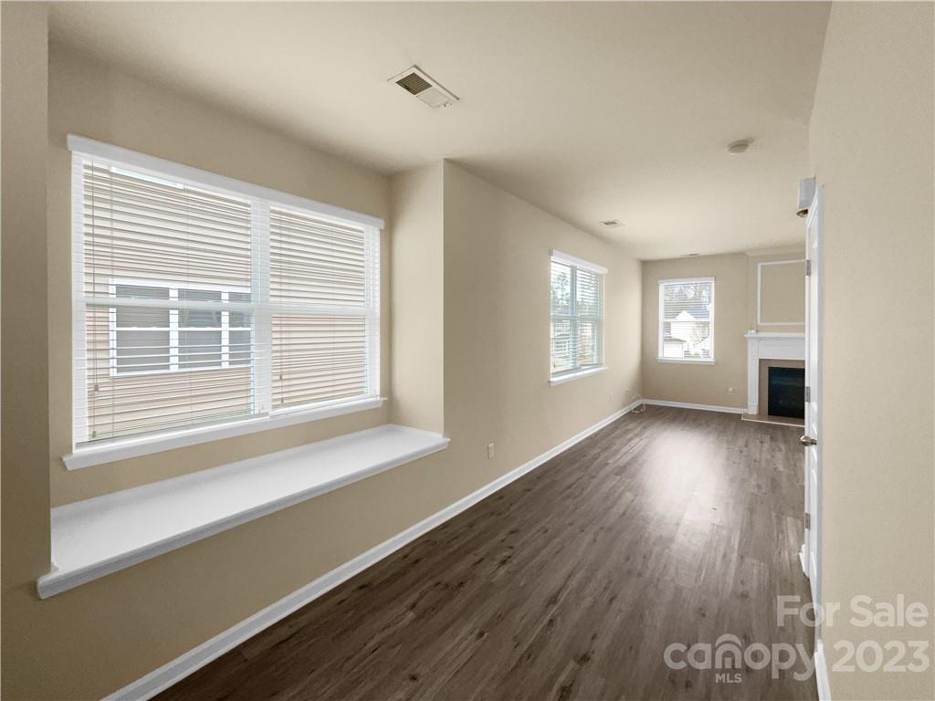 10775 Traders Court Davidson, NC 28036 - Photo 9 of 28 a view of an empty room with wooden floor and a window