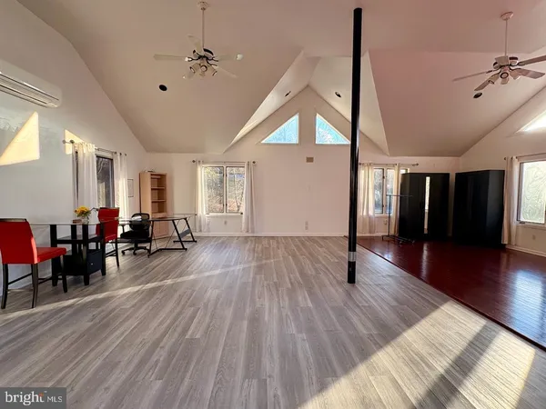 a view of a living room and a livingroom with furniture wooden floor