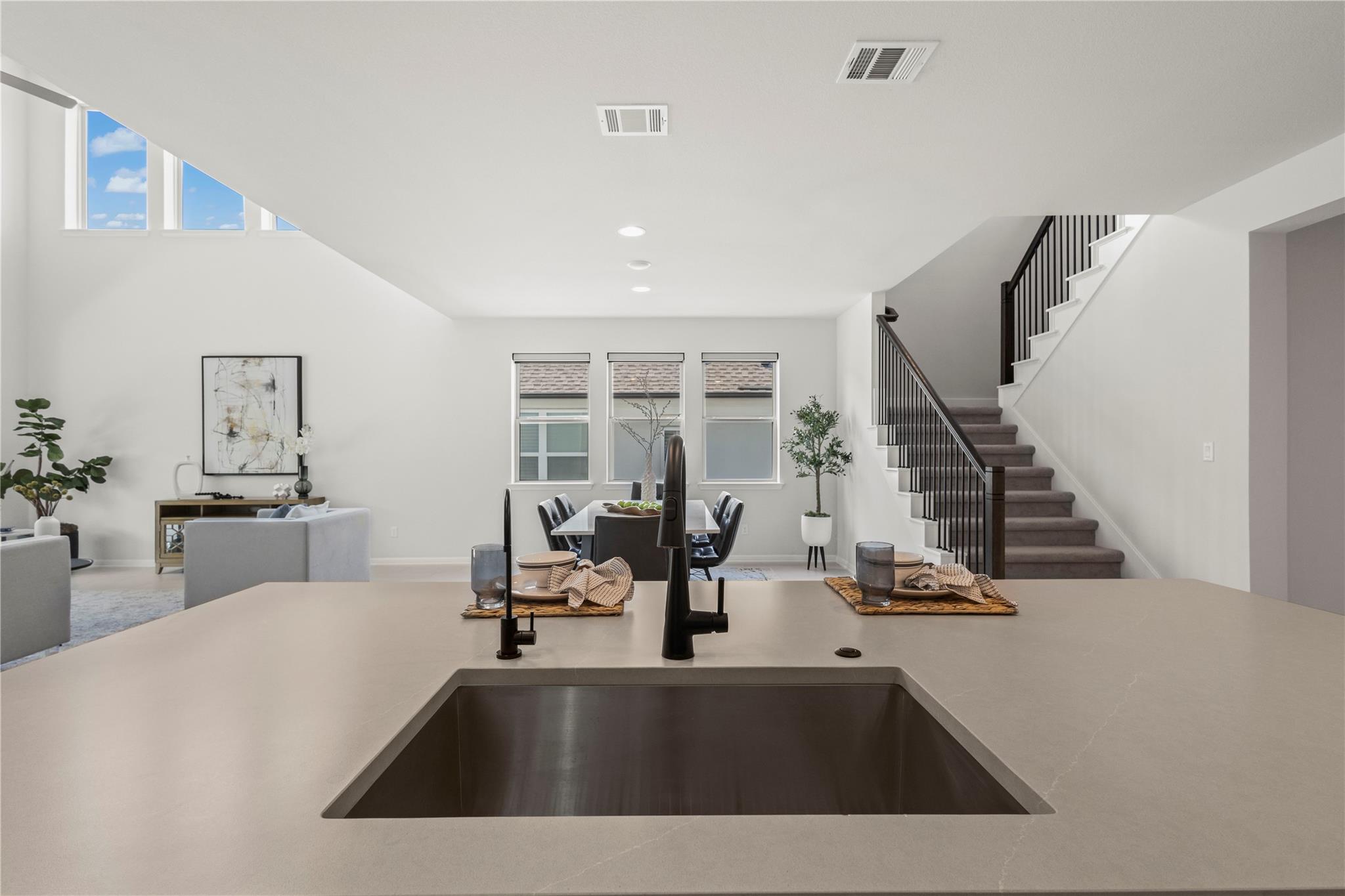 1128 Villa Rialto View Leander, TX 78641 - Photo 22 of 40 An open-concept living space with abundant natural illumination and a striking staircase.