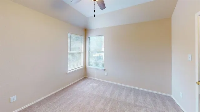 an empty room with a empty space and windows