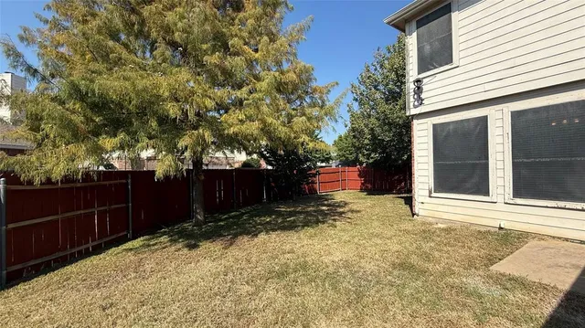 a backyard of a house with lots of green space