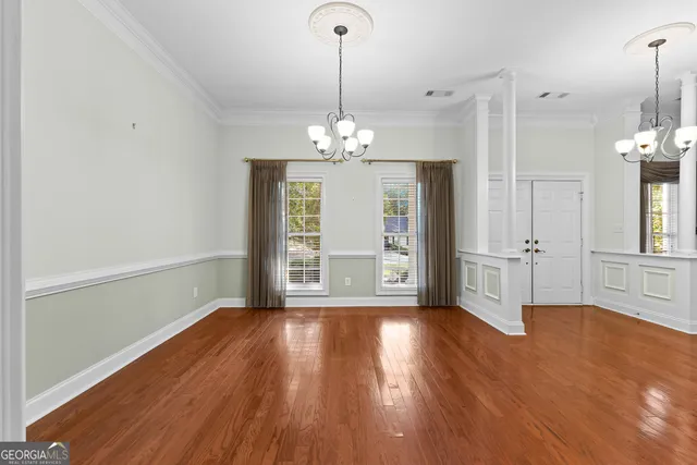 a kitchen that has a lot of cabinets and wooden floor