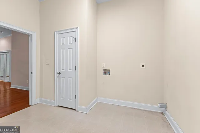 a view of empty room with wooden floor and floor to ceiling window