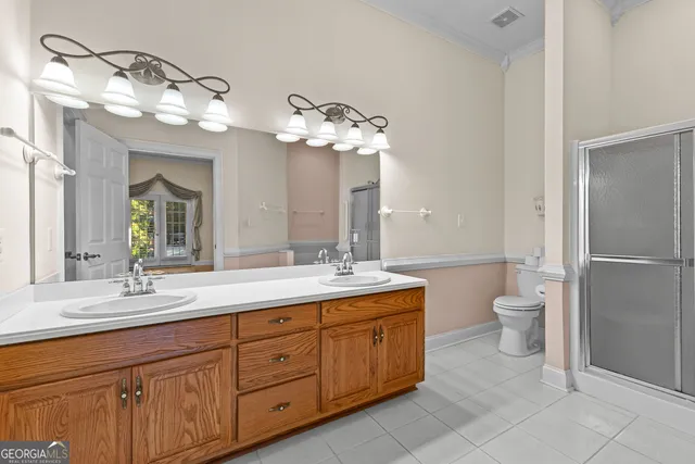 a view of an empty room with a chandelier fan
