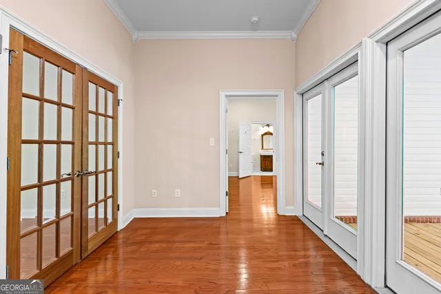 an empty room with a ceiling fan and a window