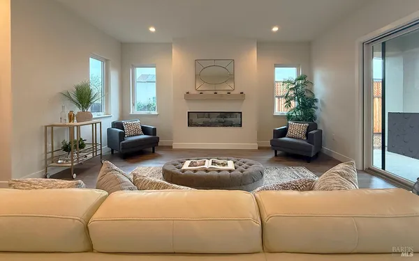 a living room with furniture and kitchen view