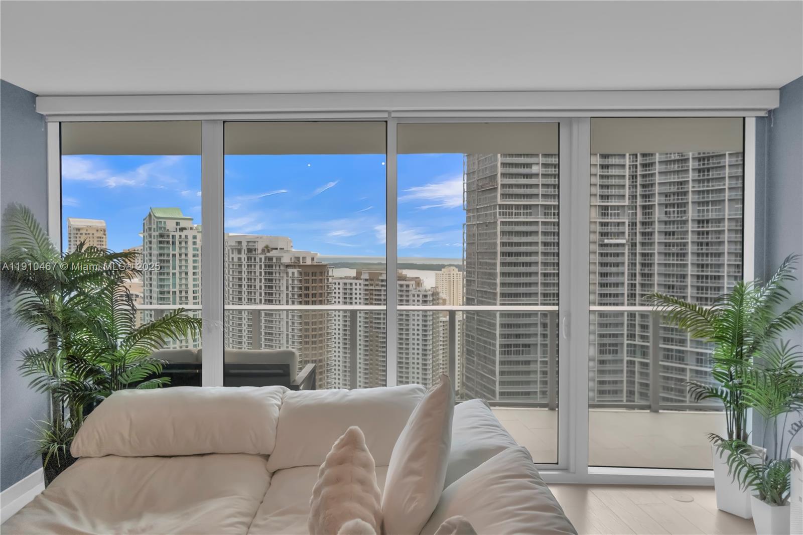 200 Biscayne Blvd Way, Unit 3907 Miami, FL 33131 - Photo 12 of 46 a view of a living room with a large window and potted plants