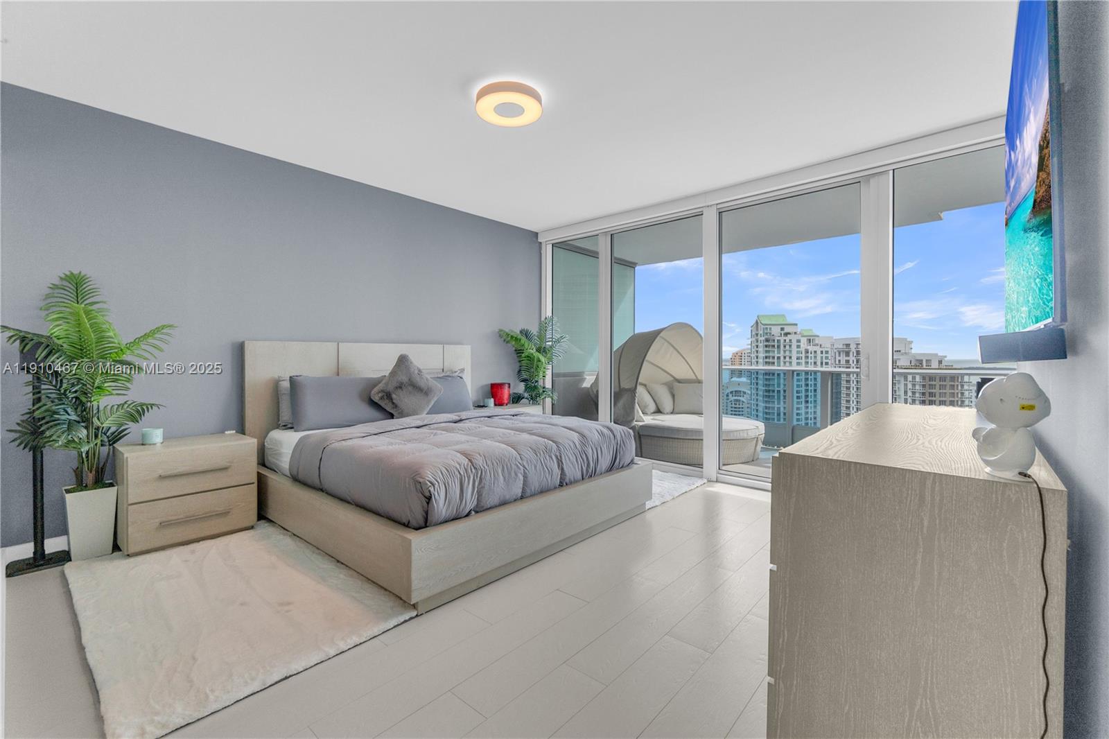 200 Biscayne Blvd Way, Unit 3907 Miami, FL 33131 - Photo 13 of 46 a bedroom with a large bed and a large window