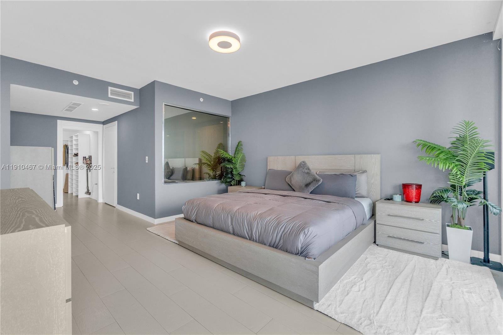 200 Biscayne Blvd Way, Unit 3907 Miami, FL 33131 - Photo 14 of 46 a spacious bedroom with a bed and a couch