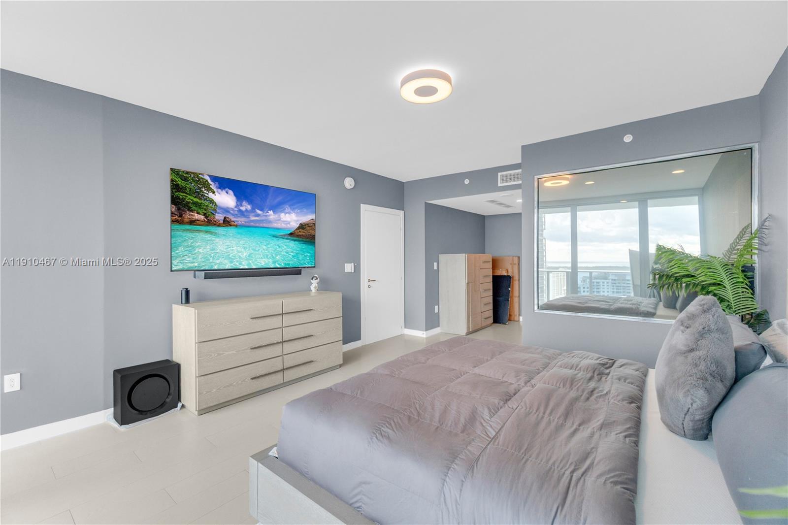 200 Biscayne Blvd Way, Unit 3907 Miami, FL 33131 - Photo 15 of 46 a bedroom with a bed and a flat screen tv