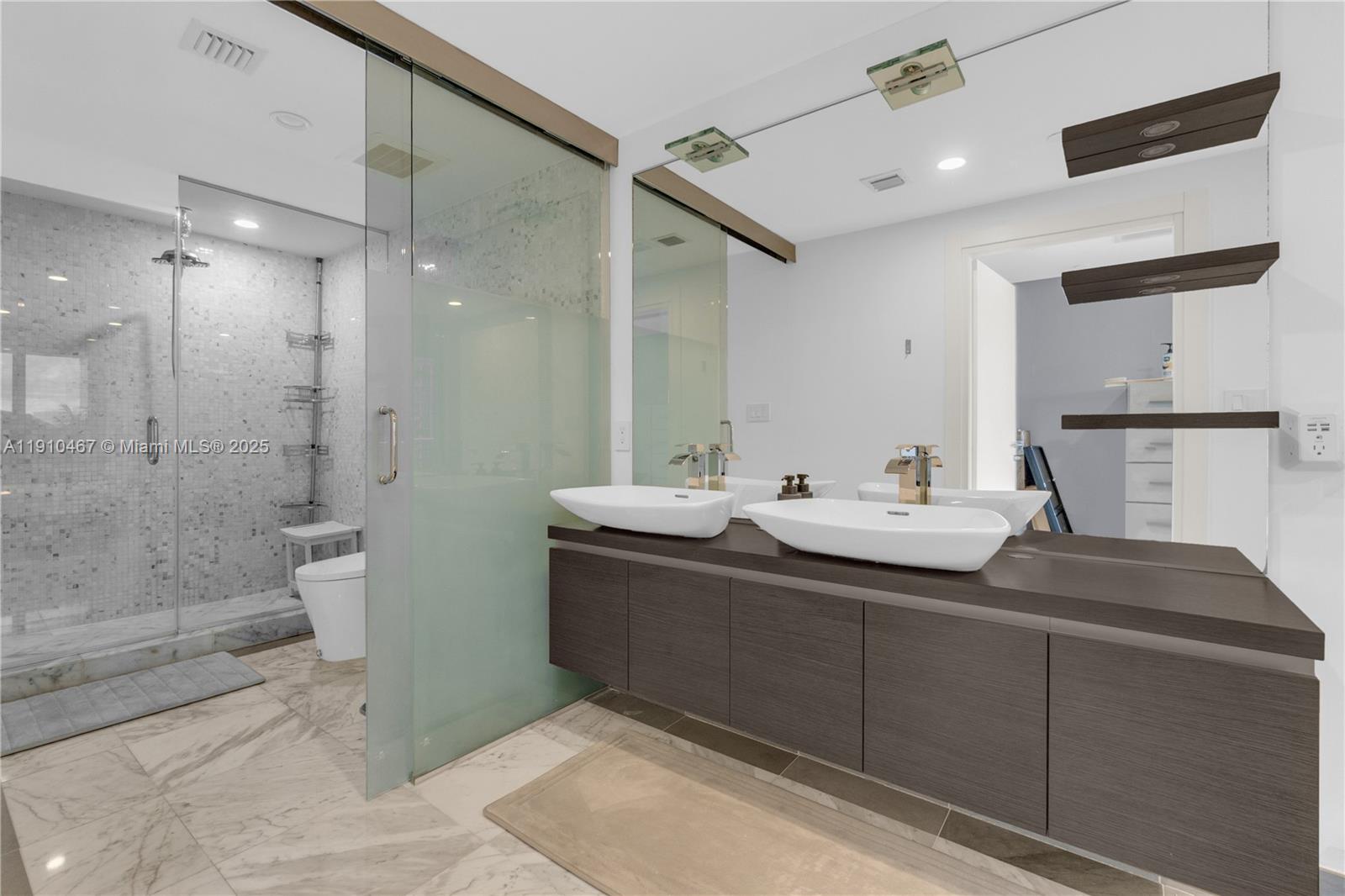 200 Biscayne Blvd Way, Unit 3907 Miami, FL 33131 - Photo 18 of 46 a bathroom with a sink mirror and a shower