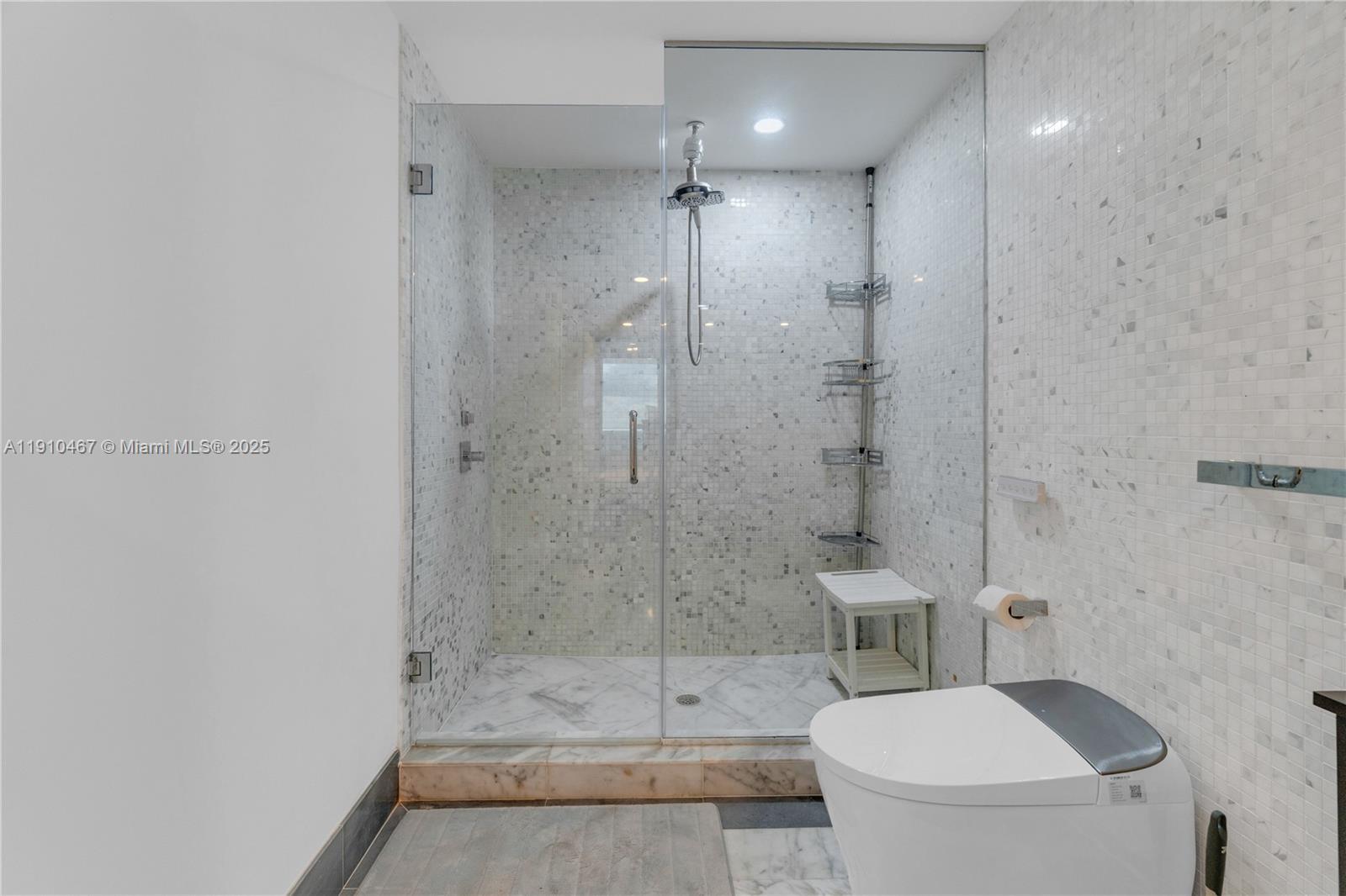 200 Biscayne Blvd Way, Unit 3907 Miami, FL 33131 - Photo 19 of 46 a bathroom with a shower a toilet and sink