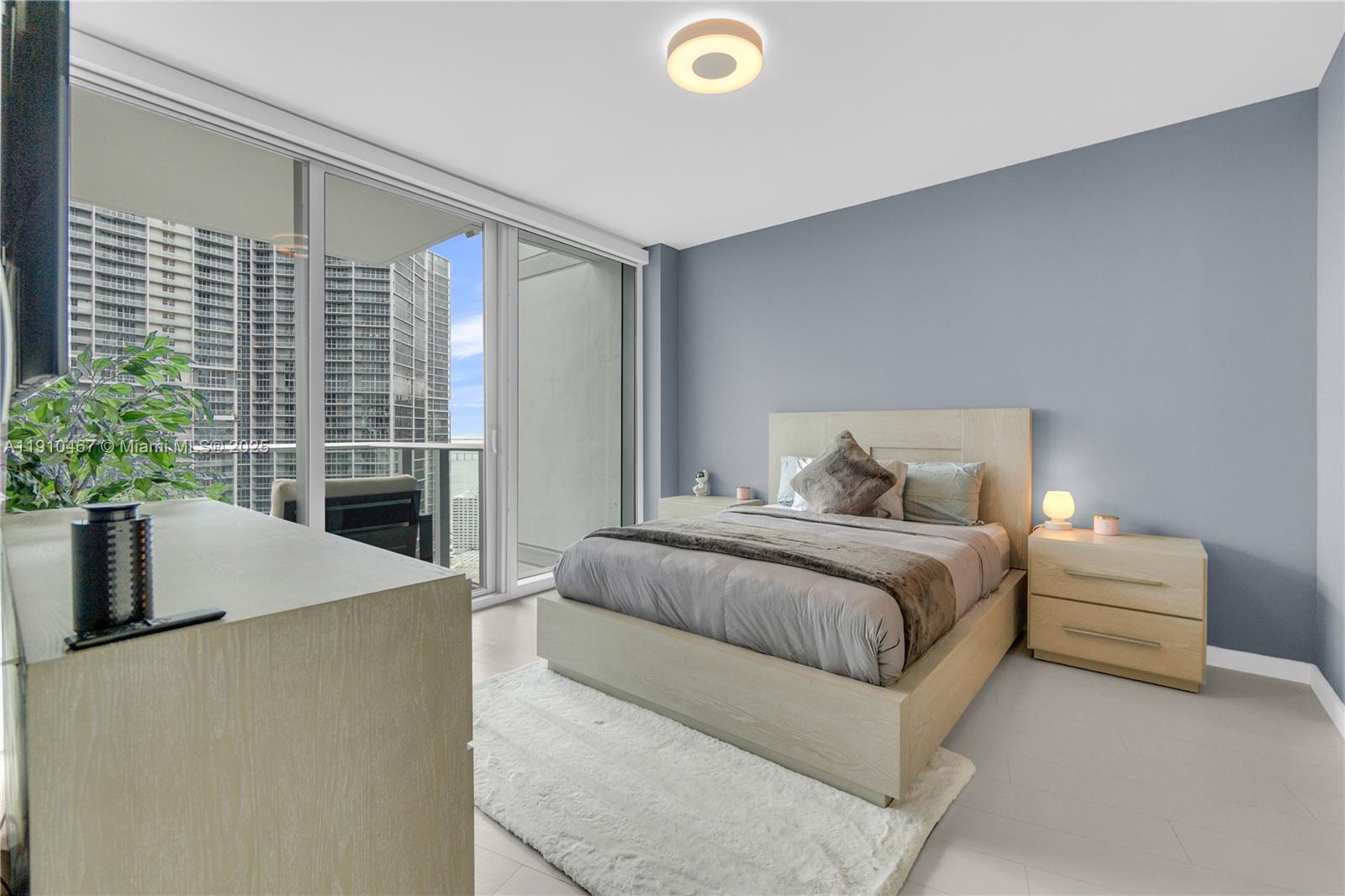 200 Biscayne Blvd Way, Unit 3907 Miami, FL 33131 - Photo 22 of 46 a bedroom with a bed and a potted plant