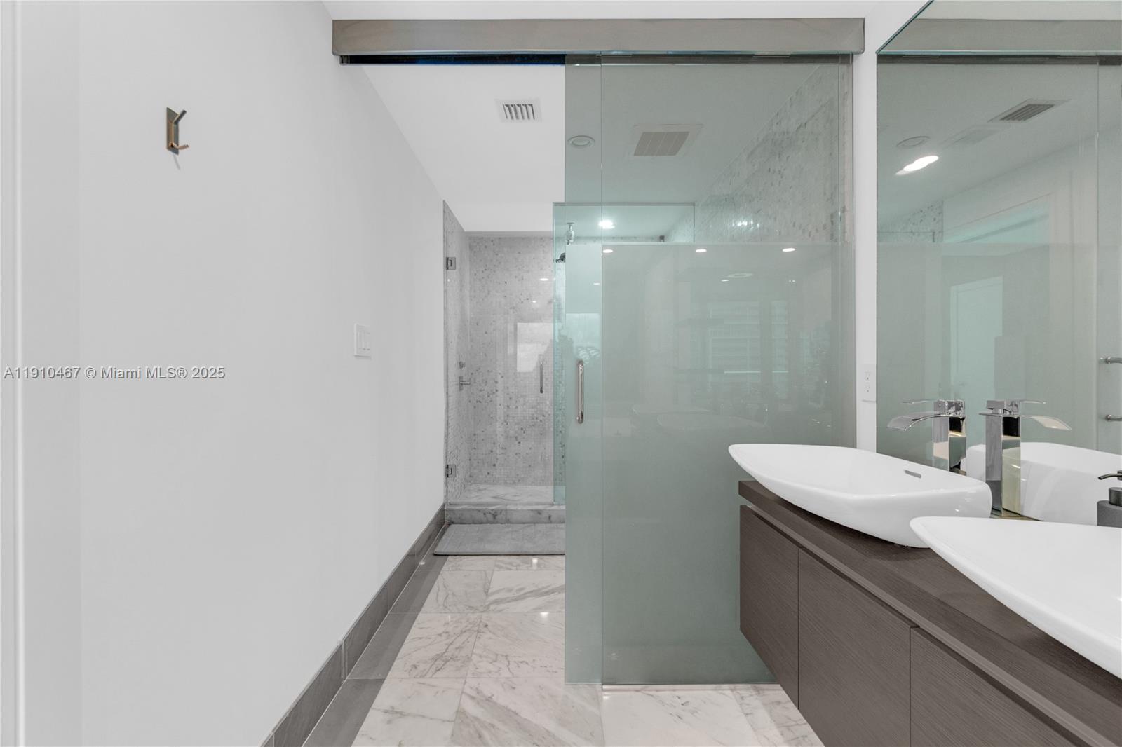 200 Biscayne Blvd Way, Unit 3907 Miami, FL 33131 - Photo 25 of 46 a bathroom with a sink a toilet and shower