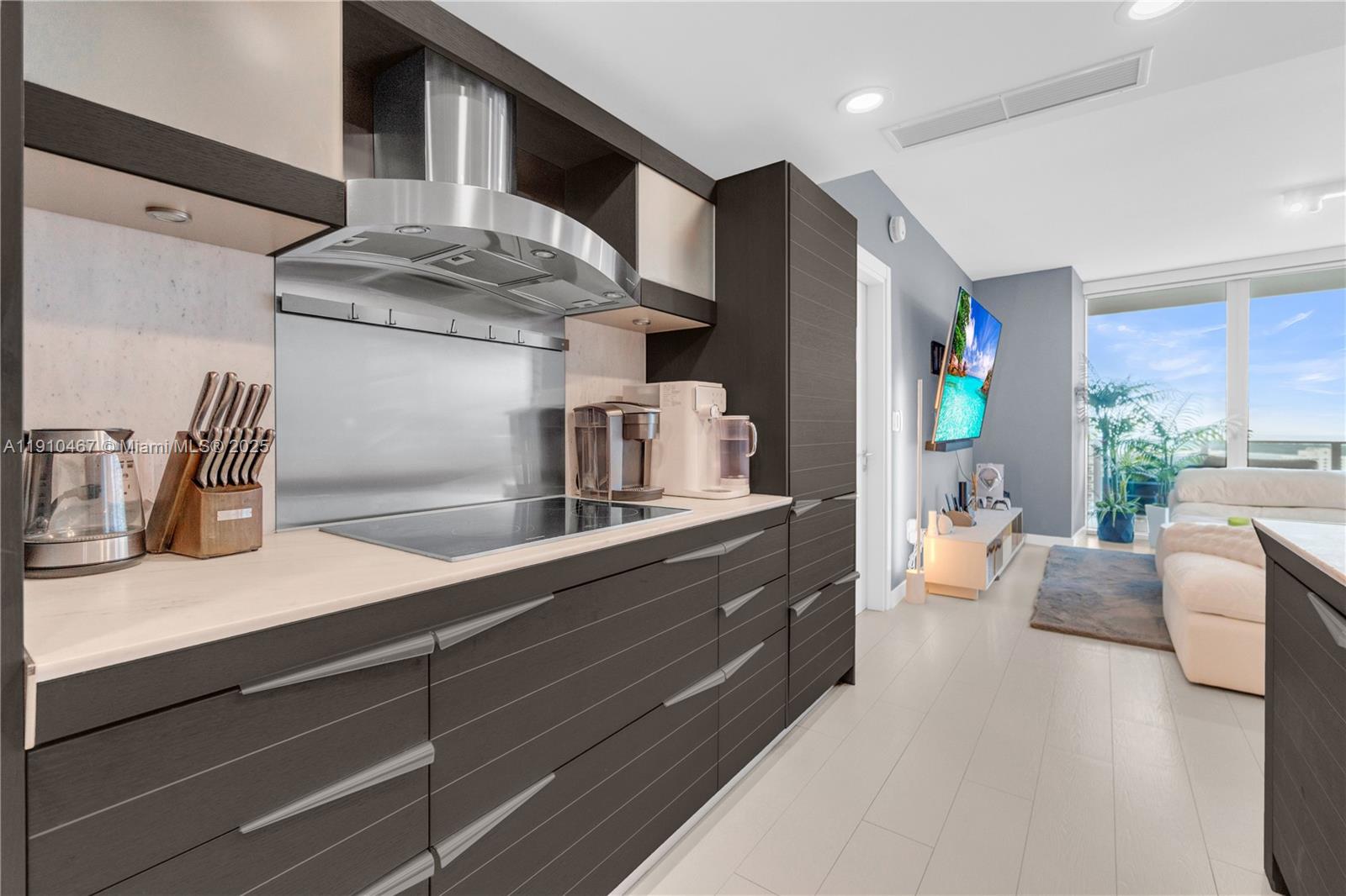 200 Biscayne Blvd Way, Unit 3907 Miami, FL 33131 - Photo 4 of 46 a kitchen with stainless steel appliances kitchen island granite countertop a refrigerator and a sink