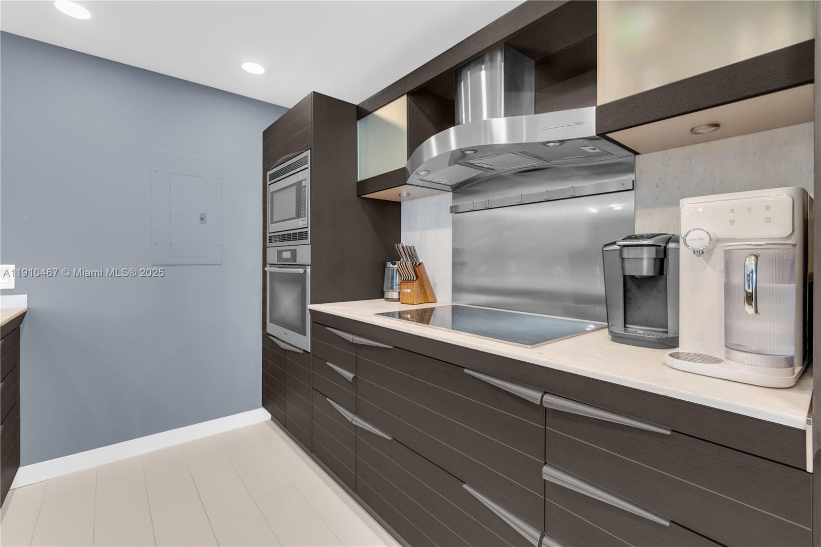 200 Biscayne Blvd Way, Unit 3907 Miami, FL 33131 - Photo 6 of 46 a kitchen with a refrigerator and cabinets