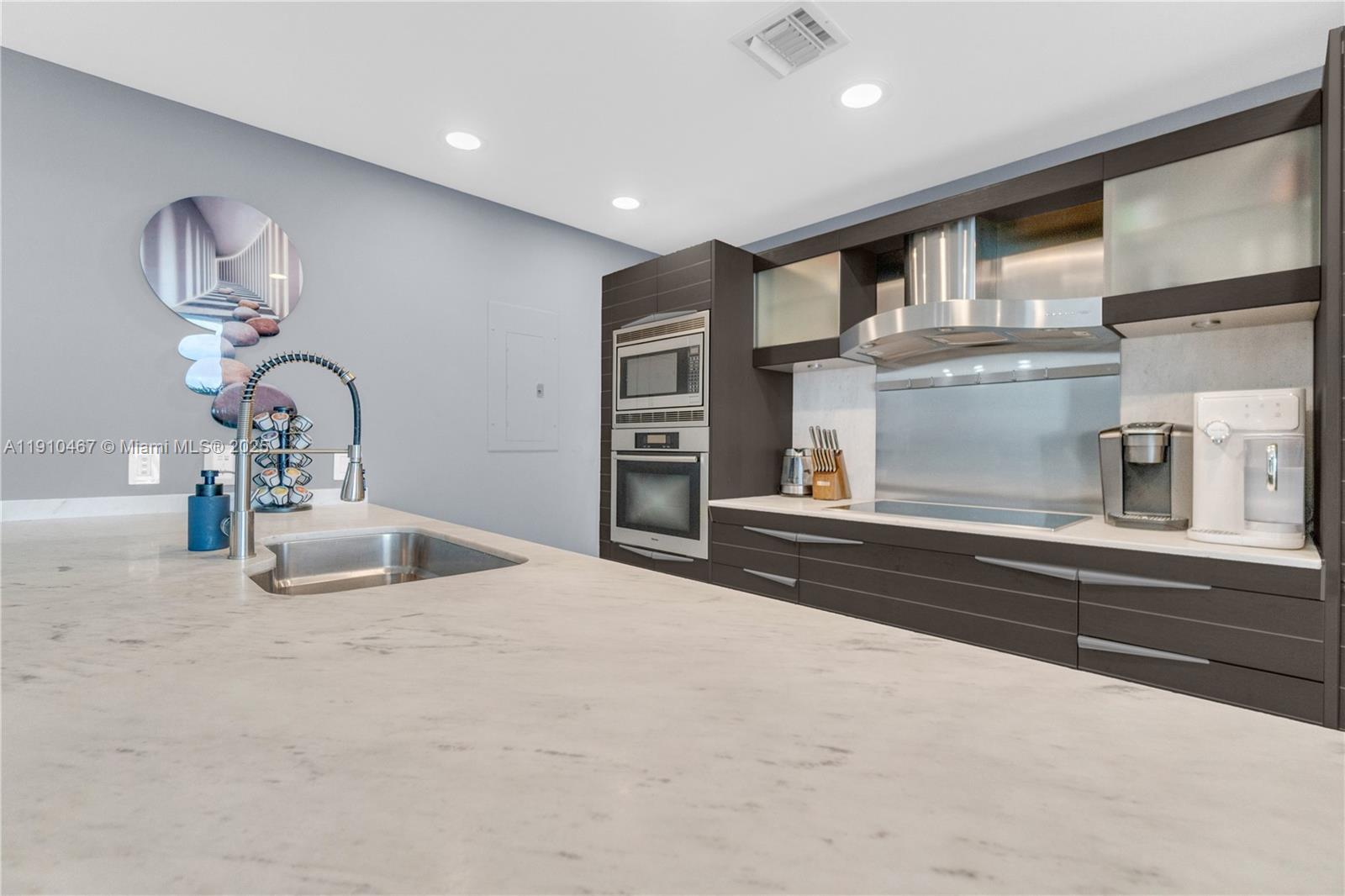 200 Biscayne Blvd Way, Unit 3907 Miami, FL 33131 - Photo 8 of 46 a kitchen with a sink and a stove top oven