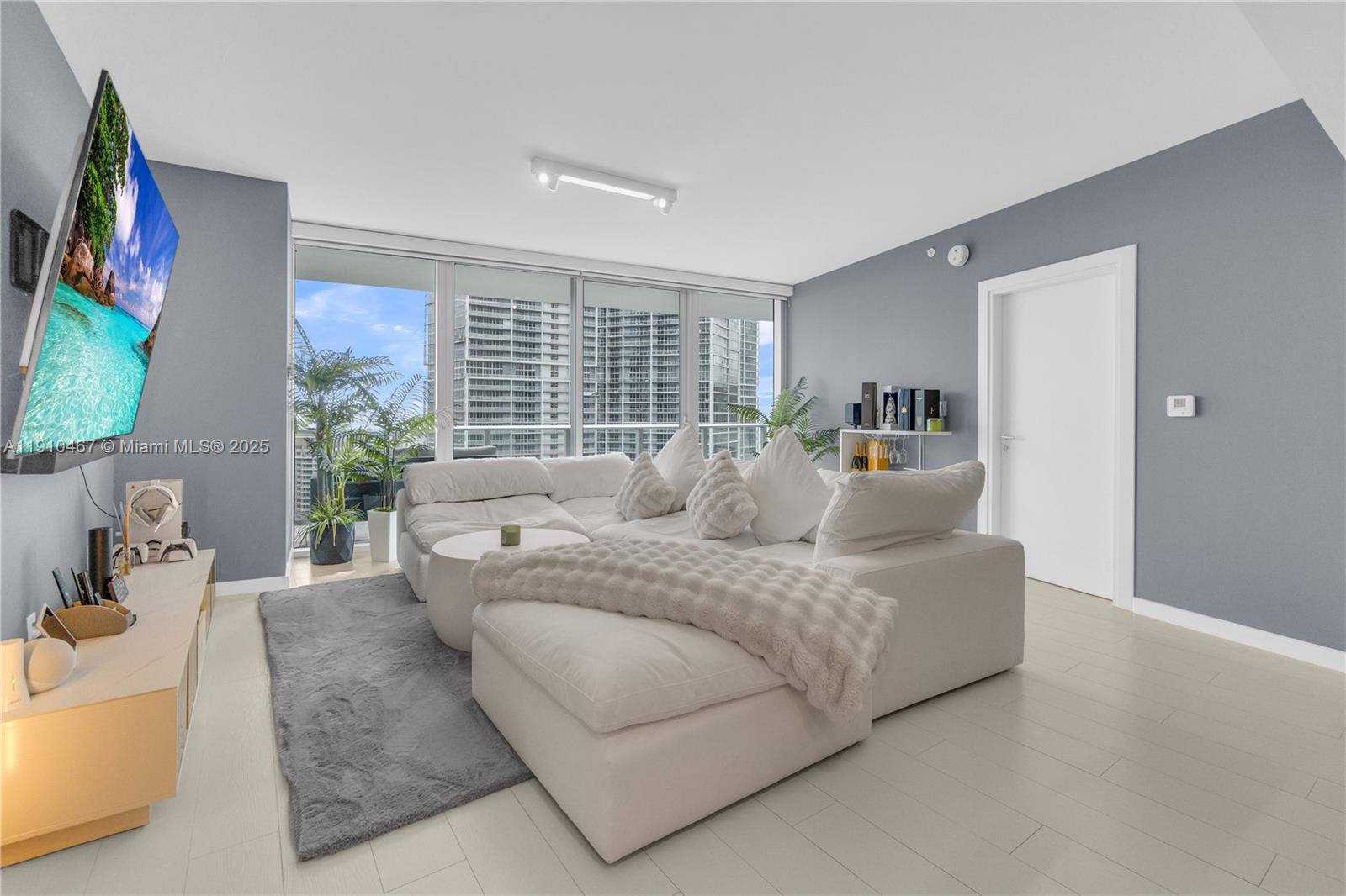 200 Biscayne Blvd Way, Unit 3907 Miami, FL 33131 - Photo 9 of 46 a living room with furniture and a flat screen tv