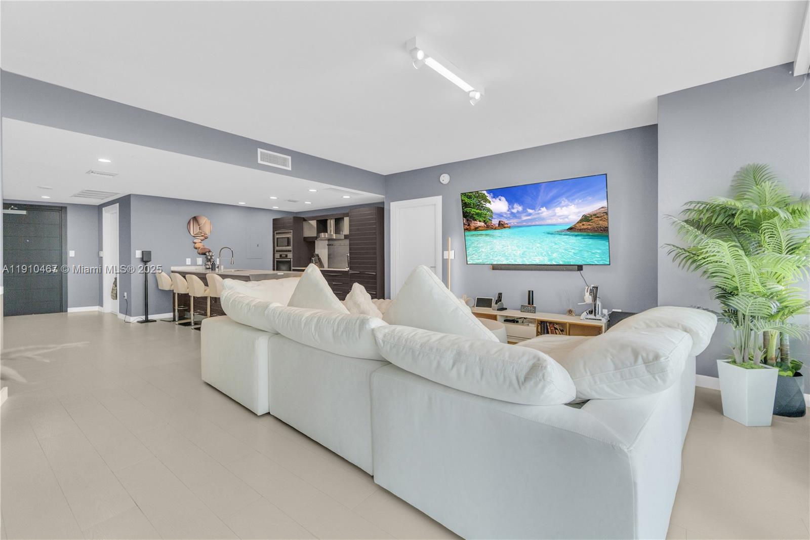 200 Biscayne Blvd Way, Unit 3907 Miami, FL 33131 - Photo 10 of 46 a living room with furniture and a flat screen tv