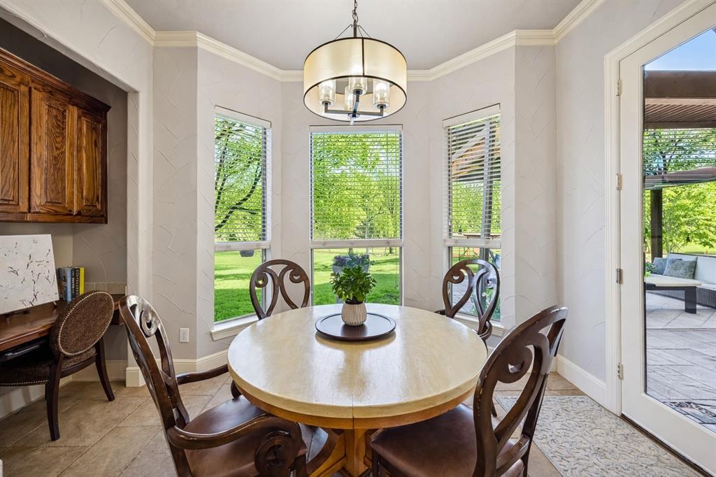 1520 Snider Court Lucas, TX 75002 - Photo 8 of 40 Charming breakfast area off the kitchen is surrounded by lovely bay windows offering a bright and cheerful setting with views of the lush backyard.