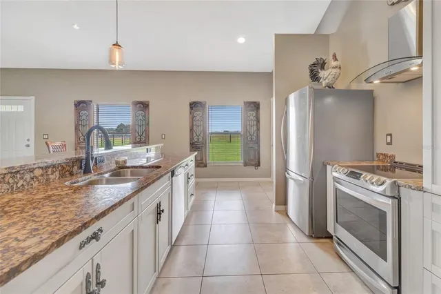 a large kitchen with kitchen island a sink stove and refrigerator