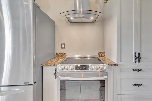 a bedroom with a bed a mirror and a window