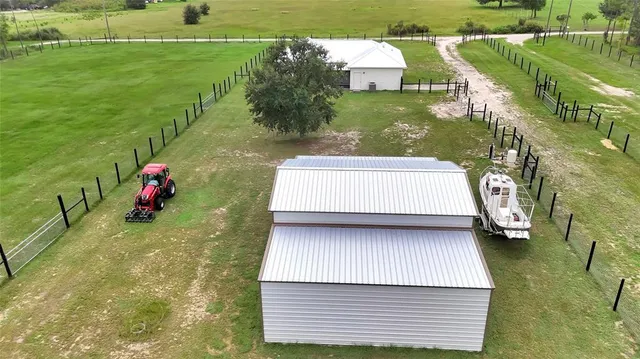 a view of a big yard with a house in the background