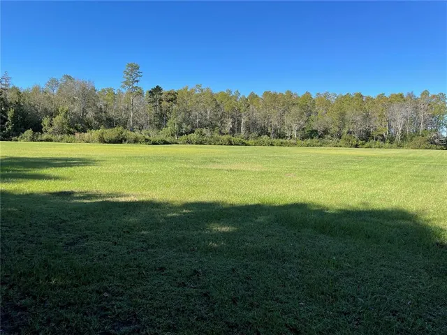a view of a field with an outdoor space