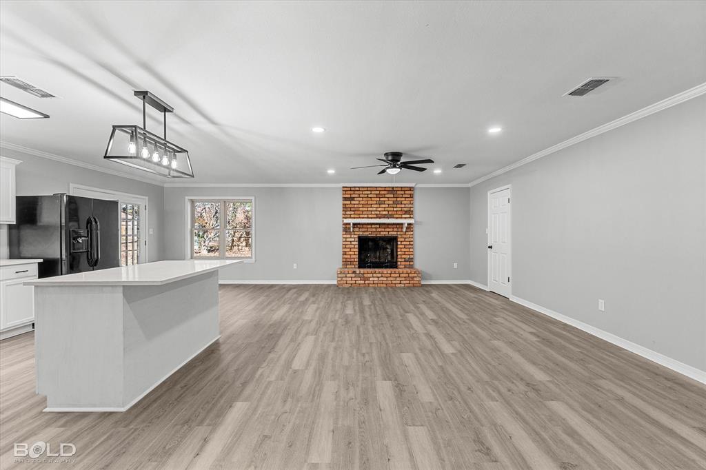 6016 Fox Ridge Shreveport, LA 71129 - Photo 16 of 33 wooden floor in an empty room with a window