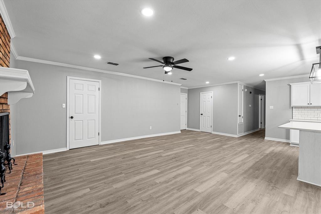 6016 Fox Ridge Shreveport, LA 71129 - Photo 17 of 33 a view of an empty room with wooden floor and a ceiling fan