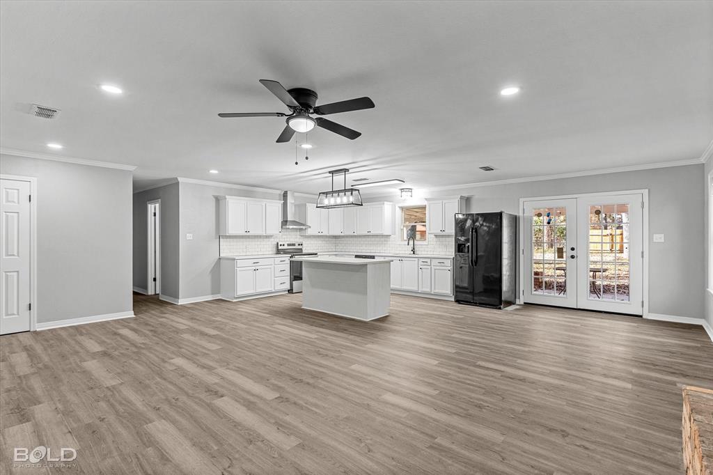 6016 Fox Ridge Shreveport, LA 71129 - Photo 18 of 33 a view of kitchen with stainless steel appliances kitchen island wooden floors granite counter tops and a window