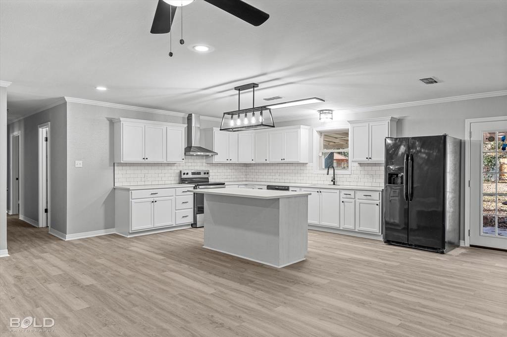 6016 Fox Ridge Shreveport, LA 71129 - Photo 19 of 33 a kitchen with white cabinets and stainless steel appliances