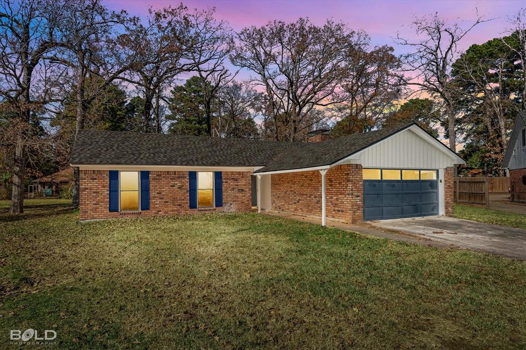 6016 Fox Ridge Shreveport, LA 71129 - Photo 2 of 33 a front view of a house with a yard and garage