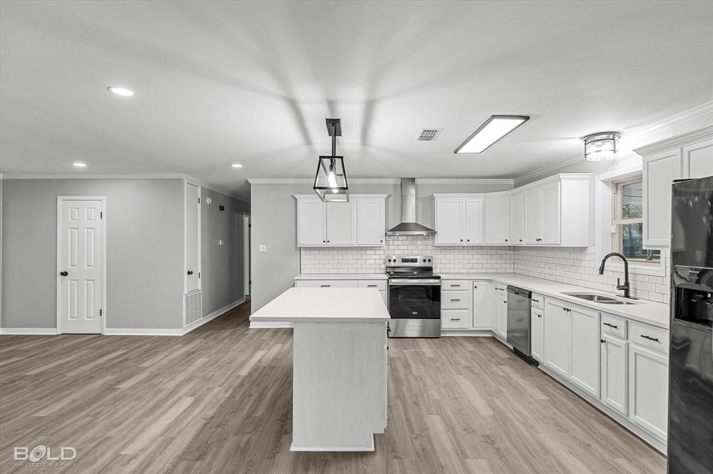 6016 Fox Ridge Shreveport, LA 71129 - Photo 21 of 33 a large kitchen with cabinets wooden floor and stainless steel appliances