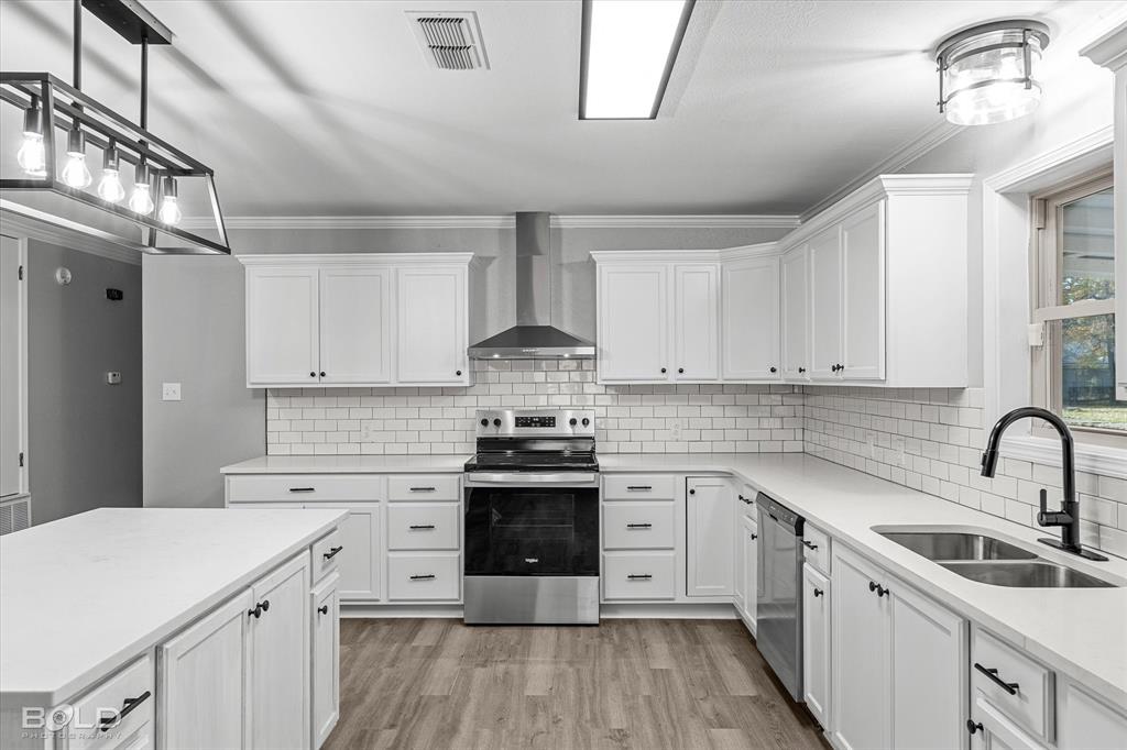 6016 Fox Ridge Shreveport, LA 71129 - Photo 22 of 33 a kitchen with cabinets stainless steel appliances a sink and wooden floor