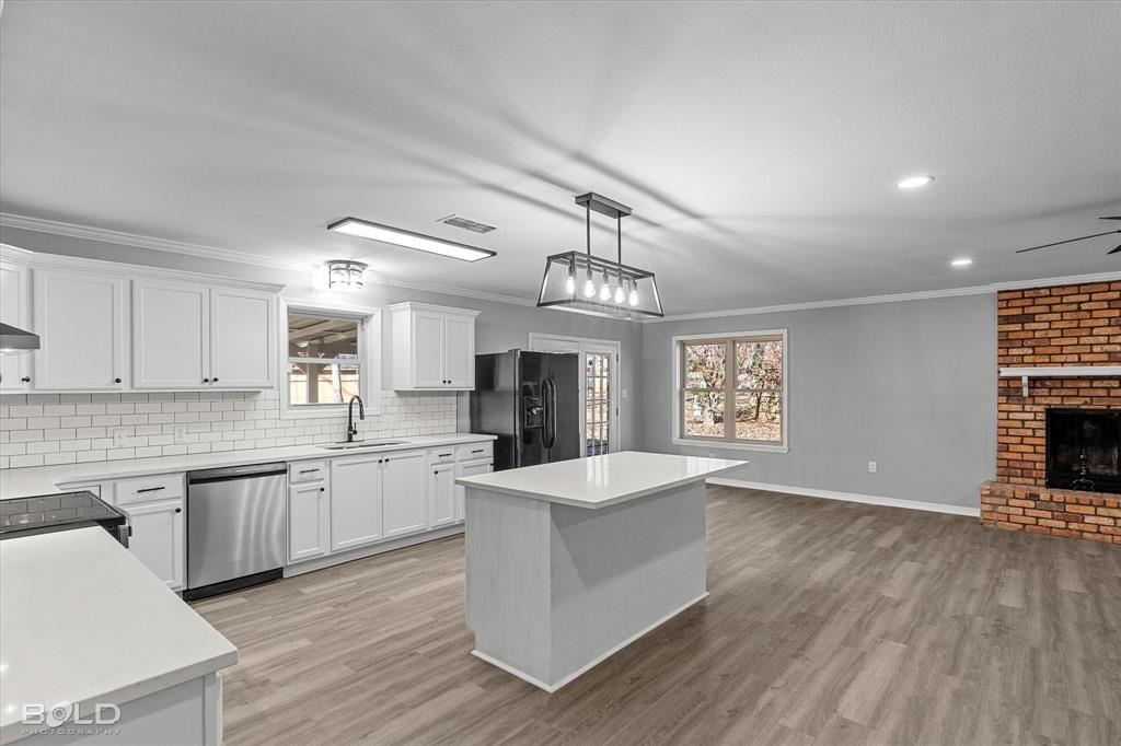 6016 Fox Ridge Shreveport, LA 71129 - Photo 24 of 33 a large kitchen with granite countertop a large counter top space a sink stainless steel appliances and cabinets