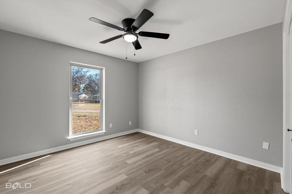 6016 Fox Ridge Shreveport, LA 71129 - Photo 29 of 33 an empty room with wooden floor and windows