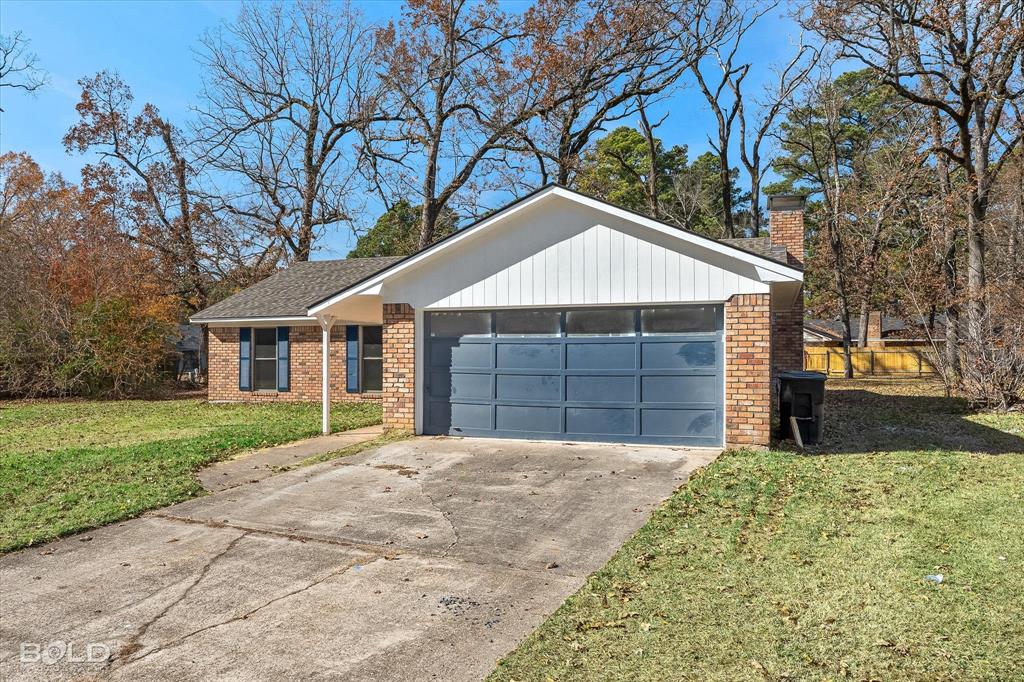 6016 Fox Ridge Shreveport, LA 71129 - Photo 6 of 33 a front view of a house with a yard and garage