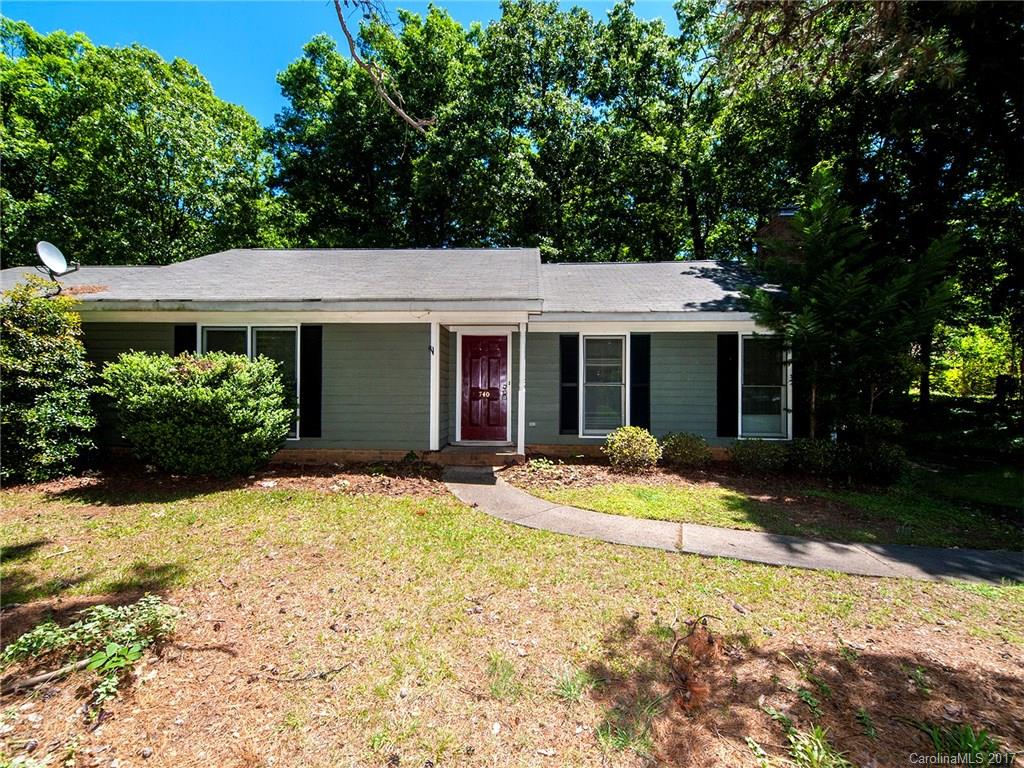 a front view of a house with a porch and a yard