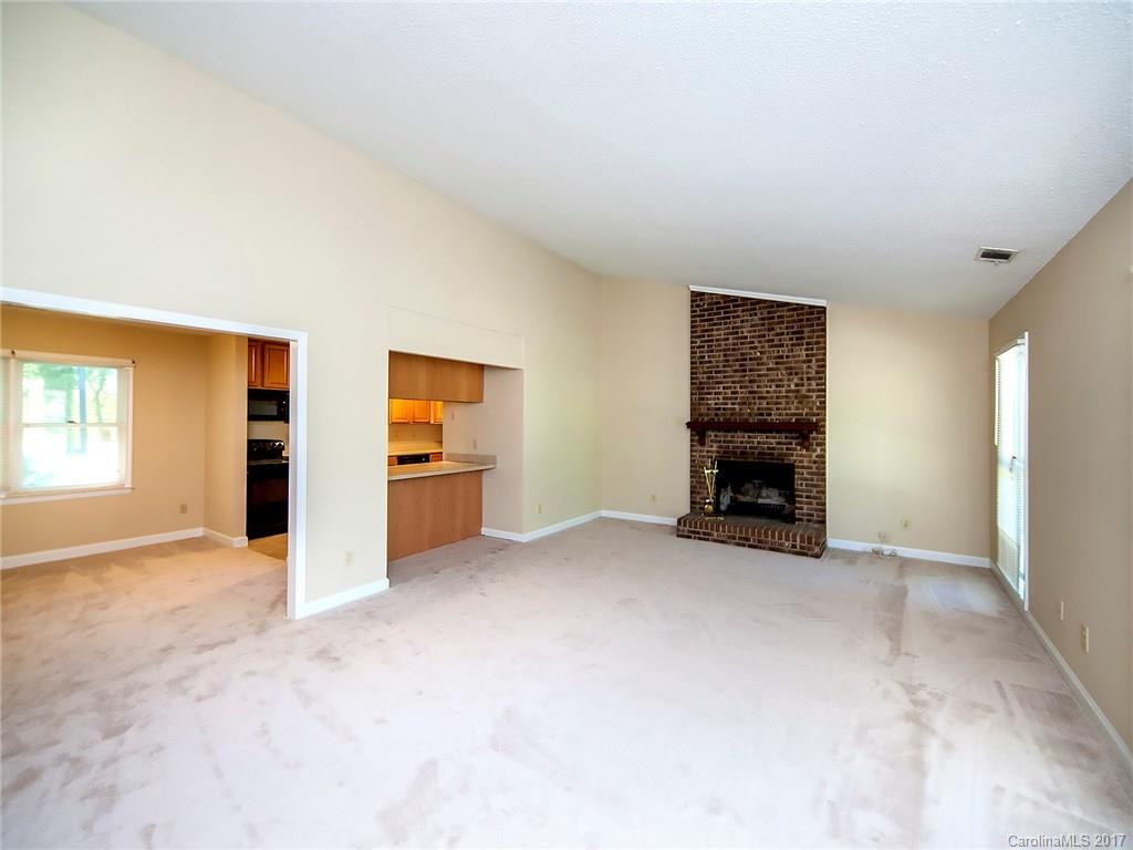 740 Rama Road Charlotte, NC 28211 - Photo 3 of 15 an empty room with furniture and a fireplace