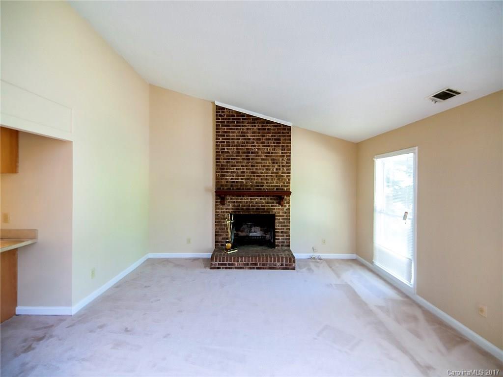 740 Rama Road Charlotte, NC 28211 - Photo 4 of 15 a view of an empty room with a fireplace and a window